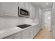 Well-equipped kitchen features stainless steel appliances, white cabinets, and a sleek stovetop at 5035 Vermillion Dr, Castle Rock, CO 80108
