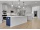 Bright white kitchen featuring stainless steel appliances, a large island, and pendant lighting above at 5035 Vermillion Dr, Castle Rock, CO 80108