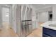 Modern kitchen features stainless steel refrigerator and white countertops with a blue kitchen island at 5035 Vermillion Dr, Castle Rock, CO 80108