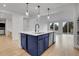 Bright kitchen with a navy blue island, stainless steel appliances, and seamless access to the outdoors at 5035 Vermillion Dr, Castle Rock, CO 80108