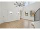 Open concept living room with a modern chandelier, large windows, and an abundance of natural light at 5035 Vermillion Dr, Castle Rock, CO 80108