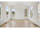Spacious living room featuring an abundance of natural light, vaulted ceilings, and light hardwood flooring at 5035 Vermillion Dr, Castle Rock, CO 80108