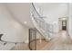 Grand staircase featuring a modern railing, neutral carpeting, and an open concept to the living room at 5035 Vermillion Dr, Castle Rock, CO 80108
