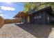 Private backyard with gravel, wood fence, and covered patio at 1020 Stuart St, Denver, CO 80204