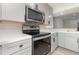 Stainless steel appliances and gray cabinets in a modern kitchen at 1020 Stuart St, Denver, CO 80204