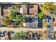 A home with a dark roof is surrounded by lush trees, offering a serene view of the property and neighborhood at 2436 W 34Th Ave, Denver, CO 80211