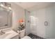 Bathroom boasts a sleek glass shower, modern fixtures, and decorative floral arrangements at 2436 W 34Th Ave, Denver, CO 80211