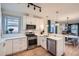 Stylish white kitchen with modern appliances, including a stainless steel dishwasher, and open layout at 2436 W 34Th Ave, Denver, CO 80211