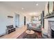 Bright living room with hardwood floors, fireplace, and neutral decor that opens to dining area at 2436 W 34Th Ave, Denver, CO 80211