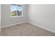 Cozy bedroom with neutral carpet, white walls, and a large window for natural light at 2143 Peralta Loop, Castle Rock, CO 80104