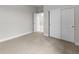Carpeted bedroom featuring double door closet and white trim throughout at 2143 Peralta Loop, Castle Rock, CO 80104