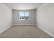 This comfortable bedroom has plush carpeting, neutral paint and a large window with neighborhood views at 2143 Peralta Loop, Castle Rock, CO 80104