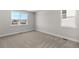 A carpeted bedroom features two large windows with views of the neighborhood at 2143 Peralta Loop, Castle Rock, CO 80104