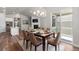 Dining room with hardwood floors, modern chandelier, and access to the outdoor patio at 2143 Peralta Loop, Castle Rock, CO 80104