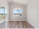 Bright dining room with patio access, lovely light fixture, and neighborhood views at 2143 Peralta Loop, Castle Rock, CO 80104