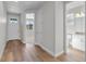 Bright entryway with light hardwood floors, white walls, and a view into other rooms at 2143 Peralta Loop, Castle Rock, CO 80104