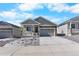 Charming single-Gathering home with stone accents, a two-car garage, and landscaping at 2143 Peralta Loop, Castle Rock, CO 80104