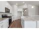 Modern kitchen with stainless steel appliances, granite countertops, and hardwood floors at 2143 Peralta Loop, Castle Rock, CO 80104