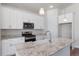 Modern kitchen with granite countertops, stainless steel appliances, and a center island at 2143 Peralta Loop, Castle Rock, CO 80104