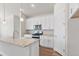 Bright kitchen features stainless steel appliances, granite countertops, and white cabinetry at 2143 Peralta Loop, Castle Rock, CO 80104