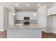 A spacious kitchen island complements white cabinets and stainless steel appliances at 2143 Peralta Loop, Castle Rock, CO 80104