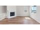Sunlit living room featuring a fireplace and light hardwood floors at 2143 Peralta Loop, Castle Rock, CO 80104