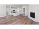Open-concept living area featuring hardwood floors, fireplace, and seamless access to kitchen at 2143 Peralta Loop, Castle Rock, CO 80104