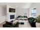 Staged living room boasts a cozy fireplace, plush seating, and ample natural light at 2143 Peralta Loop, Castle Rock, CO 80104