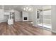 Open concept living room and kitchen featuring a fireplace, deck access and hardwood floors at 2143 Peralta Loop, Castle Rock, CO 80104