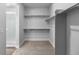 Spacious walk-in closet featuring ample shelving and convenient access to an adjacent bathroom with shower at 2143 Peralta Loop, Castle Rock, CO 80104