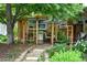Backyard patio with a grill and dining area, framed by lush greenery and a charming garden at 11224 W 28Th Pl, Lakewood, CO 80215