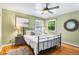 Serene bedroom with hardwood floors, ample natural light, and a ceiling fan at 11224 W 28Th Pl, Lakewood, CO 80215