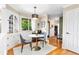 Cozy breakfast nook features a round table, hardwood floors, and a built-in cabinet near a window at 11224 W 28Th Pl, Lakewood, CO 80215
