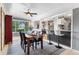 Open dining area features hardwood floors and an adjacent kitchen with bar seating for easy entertaining at 11224 W 28Th Pl, Lakewood, CO 80215
