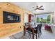 Modern dining room featuring a wood-paneled wall, contemporary lighting, and a view to the outdoors at 11224 W 28Th Pl, Lakewood, CO 80215