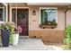 Inviting front entrance featuring a well-manicured lawn, flower boxes, and a charming wooden door, creating great curb appeal at 11224 W 28Th Pl, Lakewood, CO 80215