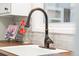 Close-up of a kitchen sink with modern faucet and stylish backsplash at 11224 W 28Th Pl, Lakewood, CO 80215