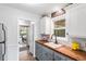 Charming kitchen with custom cabinets, butcher block countertop, and stainless steel appliances at 11224 W 28Th Pl, Lakewood, CO 80215