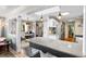 Bright, open kitchen with pendant lighting, island seating, quartz countertops, and stainless-steel appliances at 11224 W 28Th Pl, Lakewood, CO 80215