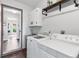 Well-equipped laundry room featuring modern washer and dryer units, storage cabinets, and updated design at 11224 W 28Th Pl, Lakewood, CO 80215