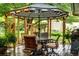Outdoor dining area on a wooden deck with a patio umbrella and a view of the landscaped garden at 11224 W 28Th Pl, Lakewood, CO 80215