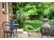 Inviting backyard patio with seating and vibrant garden views, featuring a decorative metal fire pit and mature trees at 11224 W 28Th Pl, Lakewood, CO 80215