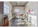 Bright home office featuring concrete ceilings, hardwood floors, and a large window providing ample natural light at 1499 Blake St # 6K, Denver, CO 80202