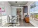Modern home office space showcasing hardwood floors, a sleek desk, and a view into the connected living area at 1499 Blake St # 6K, Denver, CO 80202