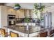 Kitchen featuring a granite island, stainless steel appliances, and hanging plants at 1499 Blake St # 6K, Denver, CO 80202