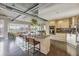 Open kitchen with a granite island, modern appliances, light wood cabinetry, and exposed ductwork at 1499 Blake St # 6K, Denver, CO 80202