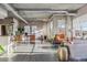 Open-concept living room with concrete ceilings, hardwood floors, and industrial-style ductwork and light fixtures at 1499 Blake St # 6K, Denver, CO 80202