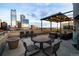 Rooftop terrace with city views, lounge area and string lights at 1499 Blake St # 6K, Denver, CO 80202