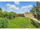 Backyard view with green lawn and detached garage, great for outdoor activities and storage at 4716 Broadway, Denver, CO 80216