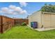 Fenced backyard with small lawn and detached garage, providing privacy and additional storage at 4716 Broadway, Denver, CO 80216